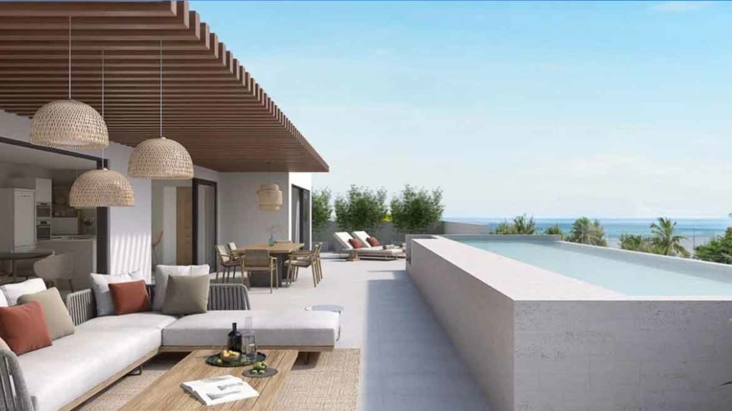 Terrasse couverte d'une villa contemporaine avec piscine à débordement et vue sur l'océan à l'île Maurice